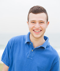 Image showing Smart young man smiling at the beach