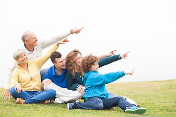 Image showing Happy family pointing away