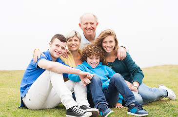 Image showing Happy family sitting in the lawn