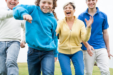 Image showing Happy family playing on lawn