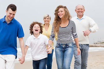 Image showing Happy family walking on the beach