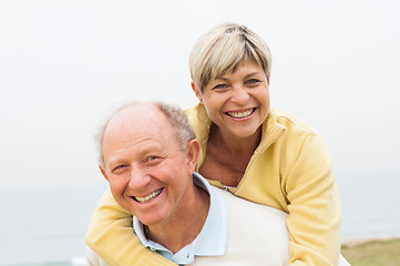 Image showing Mature man giving woman piggyback