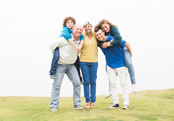 Image showing Happy family standing together in lawn