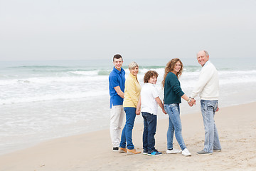 Image showing Happy family walking on beach