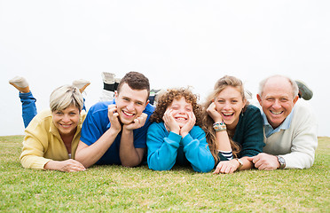 Image showing Happy family lying on green lawn