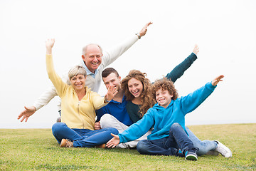 Image showing Happy family playing in the grass