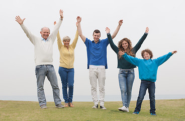 Image showing Happy family raised their hands