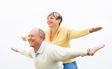 Image showing Happy man giving piggyback to woman