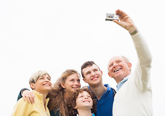 Image showing Smiling family taking photos