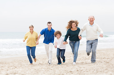 Image showing Happy family jugging at the beach