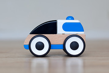 Image showing Simple wood and plastic toy police car