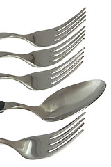 Image showing A spoon among some forks

