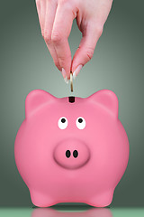 Image showing Fingers and piggy bank