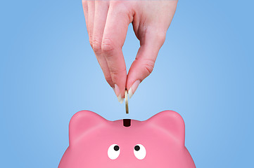 Image showing Hand and piggy bank