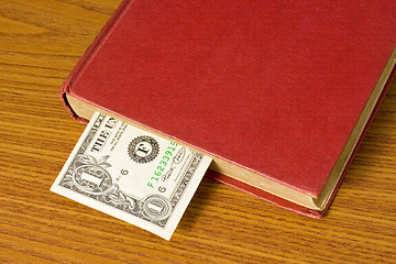 Image showing Dollar bill in book

