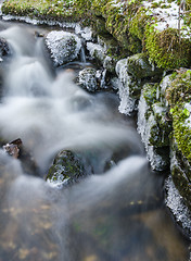 Image showing The flow of water in the spring of icicles and ice