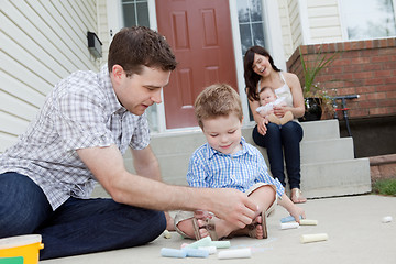 Image showing Father And Son Drawing With Chalk on Sidwalk