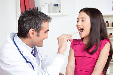 Image showing Doctor Examining a Child Mouth