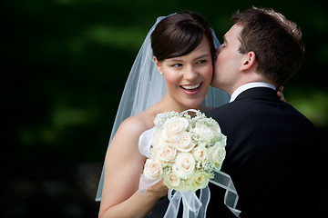 Image showing Groom Kissing Bride on Ear