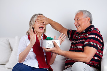 Image showing Senior Man Giving Gift to His Wife