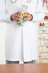 Image showing Doctor Holding Pills Bottle