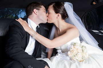 Image showing Newlywed Couple Kissing In Limousine