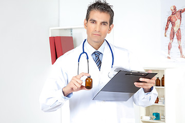 Image showing Doctor Holding Clipboard and Bottle