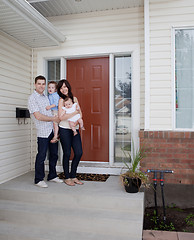 Image showing Young Family in Front of House