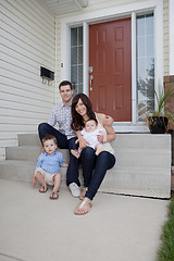 Image showing Family Portrait Sitting In Front Of Their House