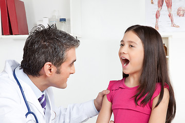 Image showing Doctor Examining a Child Mouth