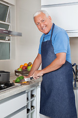 Image showing Senior Man Cutting Vegetables