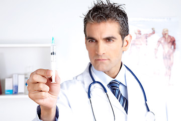 Image showing Male Doctor Looking at Syringe