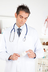 Image showing Doctor Holding Pills Bottle