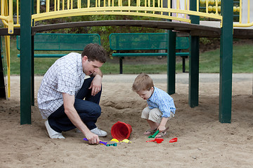 Image showing Father And Son Playing At Playground In Sand