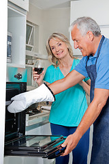 Image showing Man Baking Food in Oven