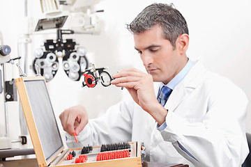 Image showing Optometrist Holding Measuring Eye Glasses