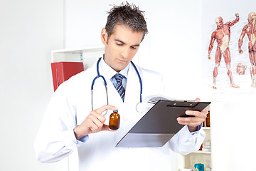 Image showing Doctor Holding Clipboard and Bottle