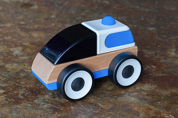 Image showing Simple wood and plastic toy police car