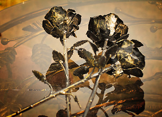Image showing The shiny metal forged roses, handmade