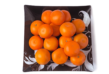 Image showing Large ripe tangerines in a glass dish on a white background.