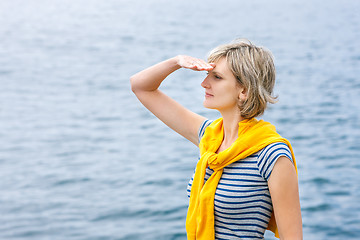 Image showing Middle age woman outdoors  looking in distance