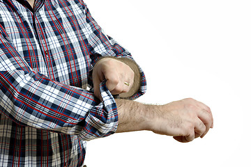 Image showing Man rolls up sleeves