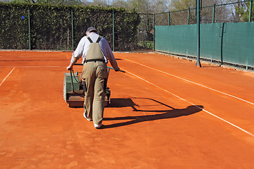 Image showing Rolling a tennis court