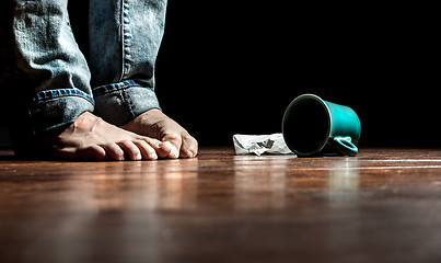 Image showing Feet in front of dropped cup