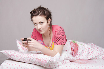 Image showing She wrote a SMS, lying in bed