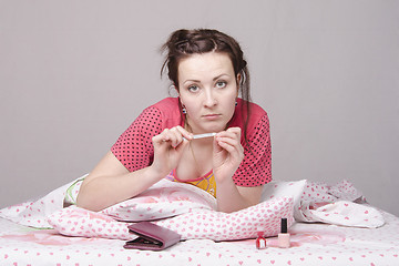 Image showing Girl ? bed engaged in manicure