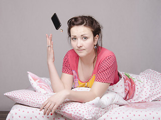 Image showing Young girl in the bed and threw phone