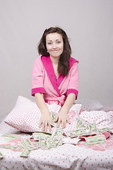 Image showing Girl in bed unexpectedly received an inheritance