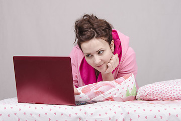 Image showing Girl in bed playing with the laptop