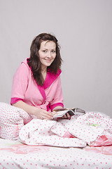 Image showing Girl in bed with magazine